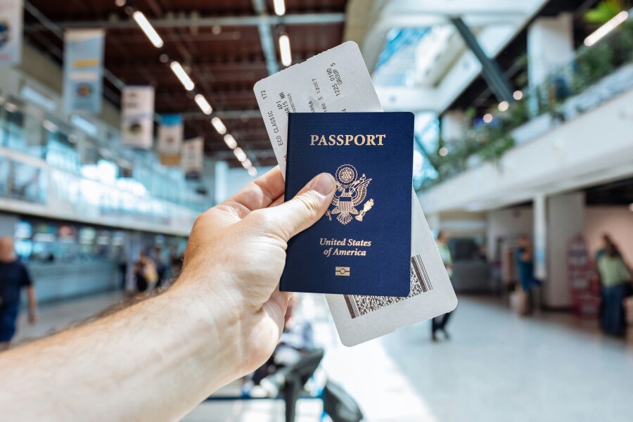 Customer holding a newly renewed passport with photo services completed at Fingerscan Digital Inc in Las Vegas.