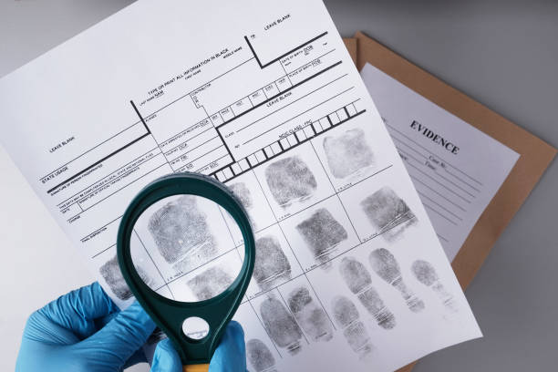 A fingerprint card with inked fingerprints of the right thumb, right index, and right middle fingers clearly visible. A black ink pad is placed at the top left corner of the image.