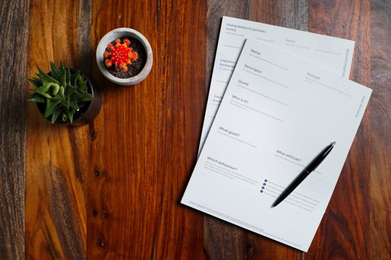 Documents and a pen on a table, representing an apostille submission being reviewed for errors