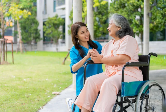 In-home caregiver cleared through Live Scan before assisting a senior client in a wheelchair