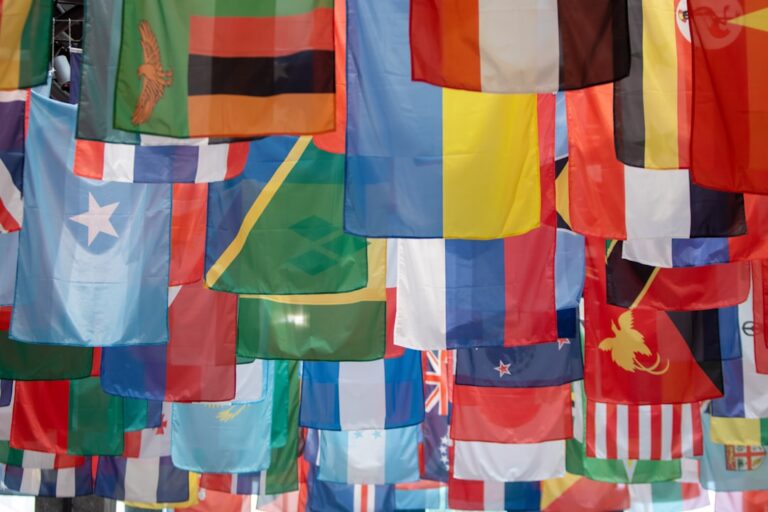 Flags of many nations at an international venue, representing apostille documents bound for Spain