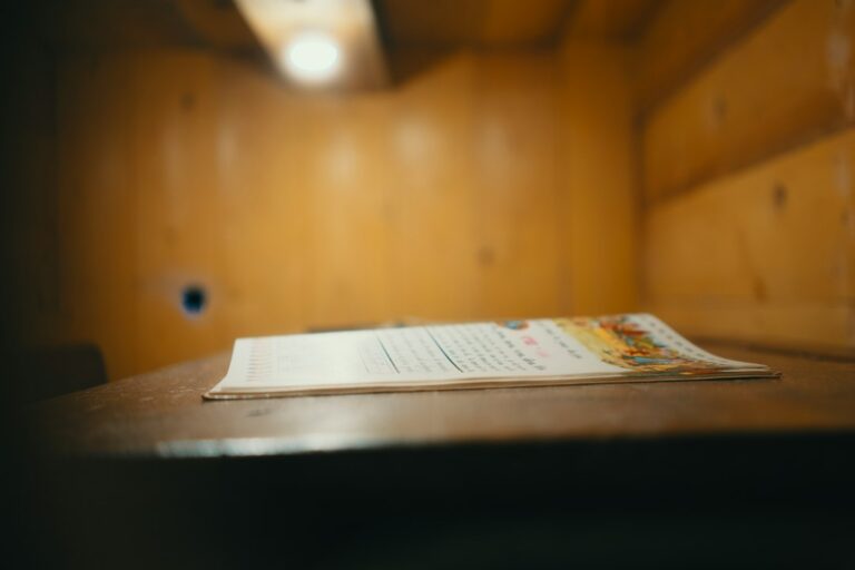 Person reviewing a document at a desk, representing an FBI Identity History Summary request