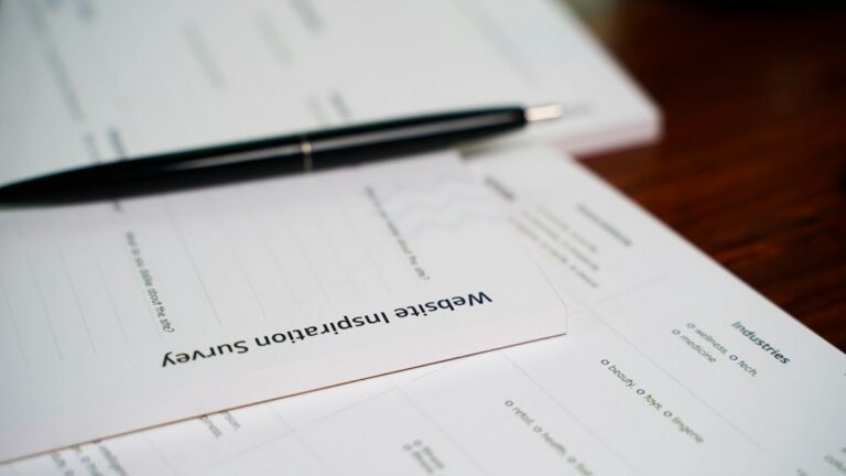 Documents and pen on a wooden table, representing a divorce decree prepared for apostille